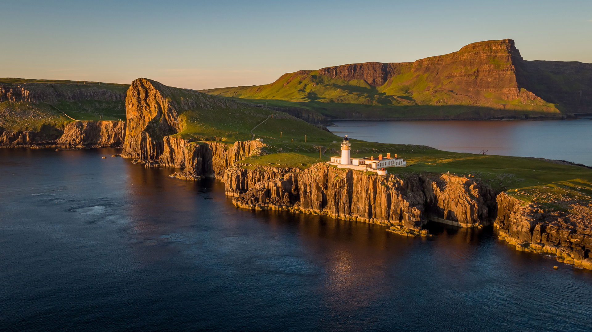 Aerial view of Neist Point lighthouse at golden hour