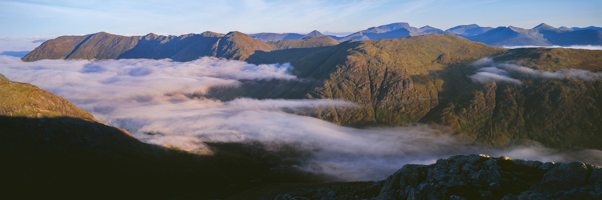 Stunning panoramic view of Scottish Highland mountains with dramatic cloud inversion