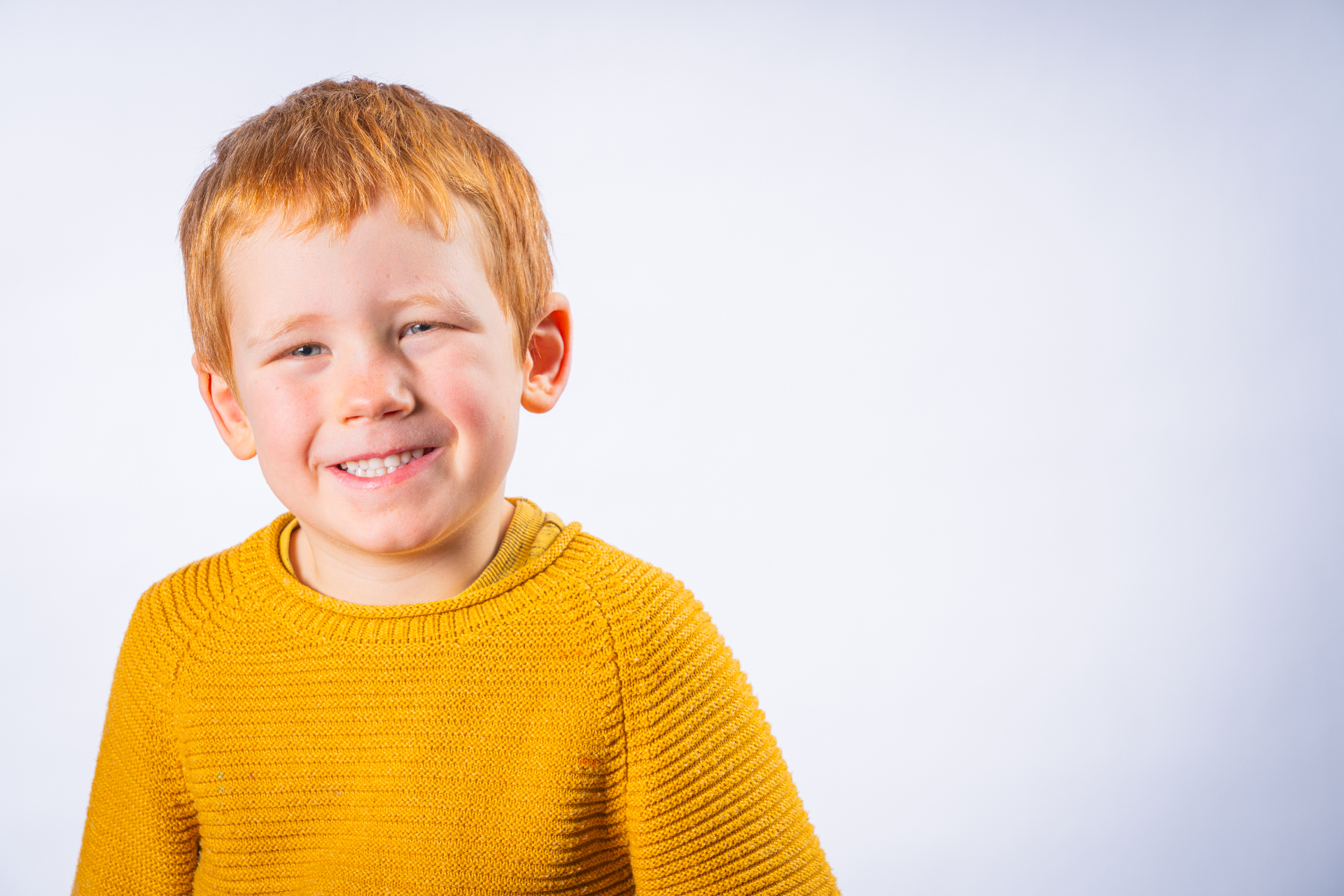 Individual school portrait - boy in yellow jumper