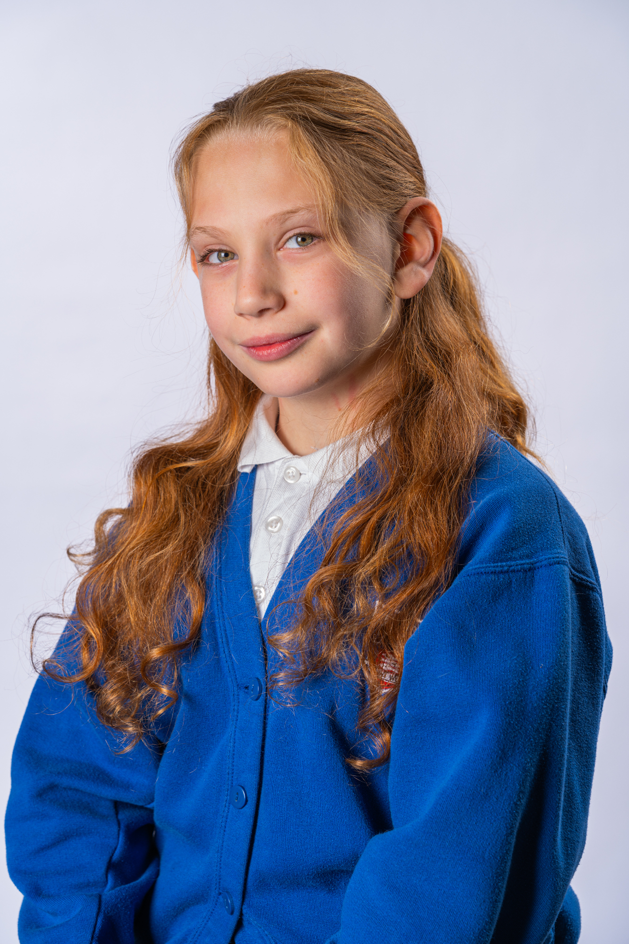 Individual school portrait - girl in blue cardigan