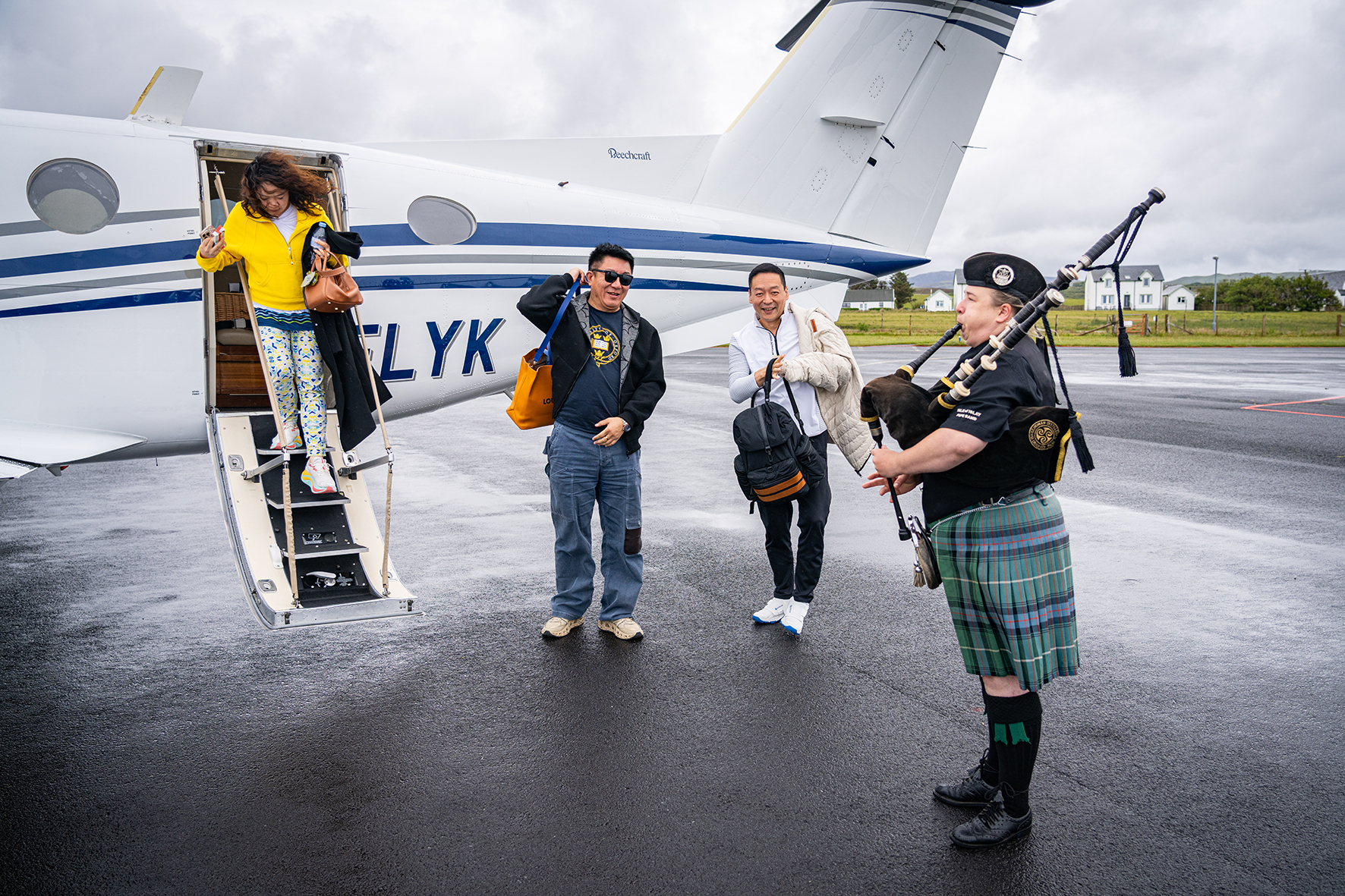 Private arrival greeted by bagpiper at Islay
