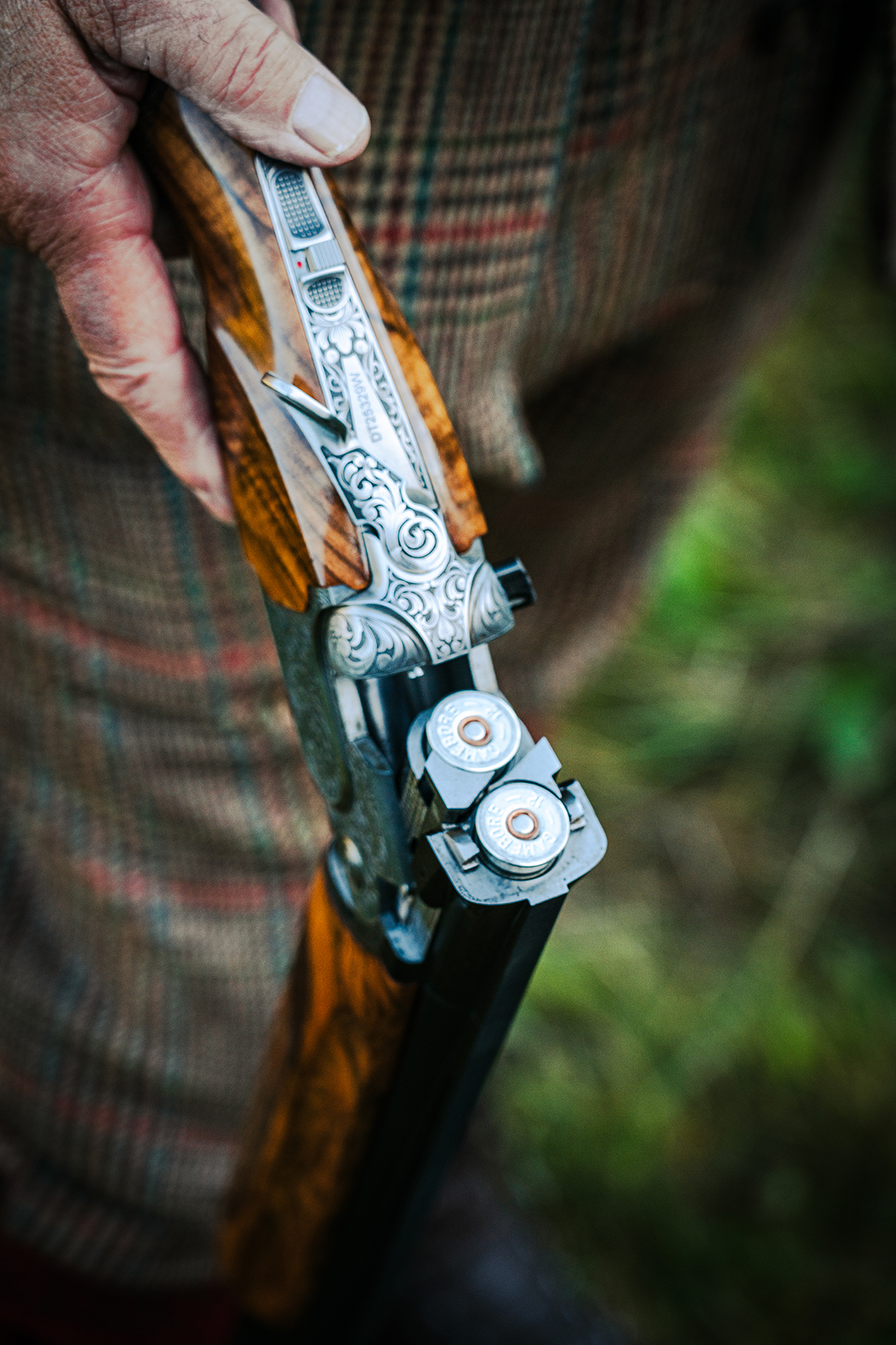Close-up detail of ornately engraved shotgun at fieldsports shoot
