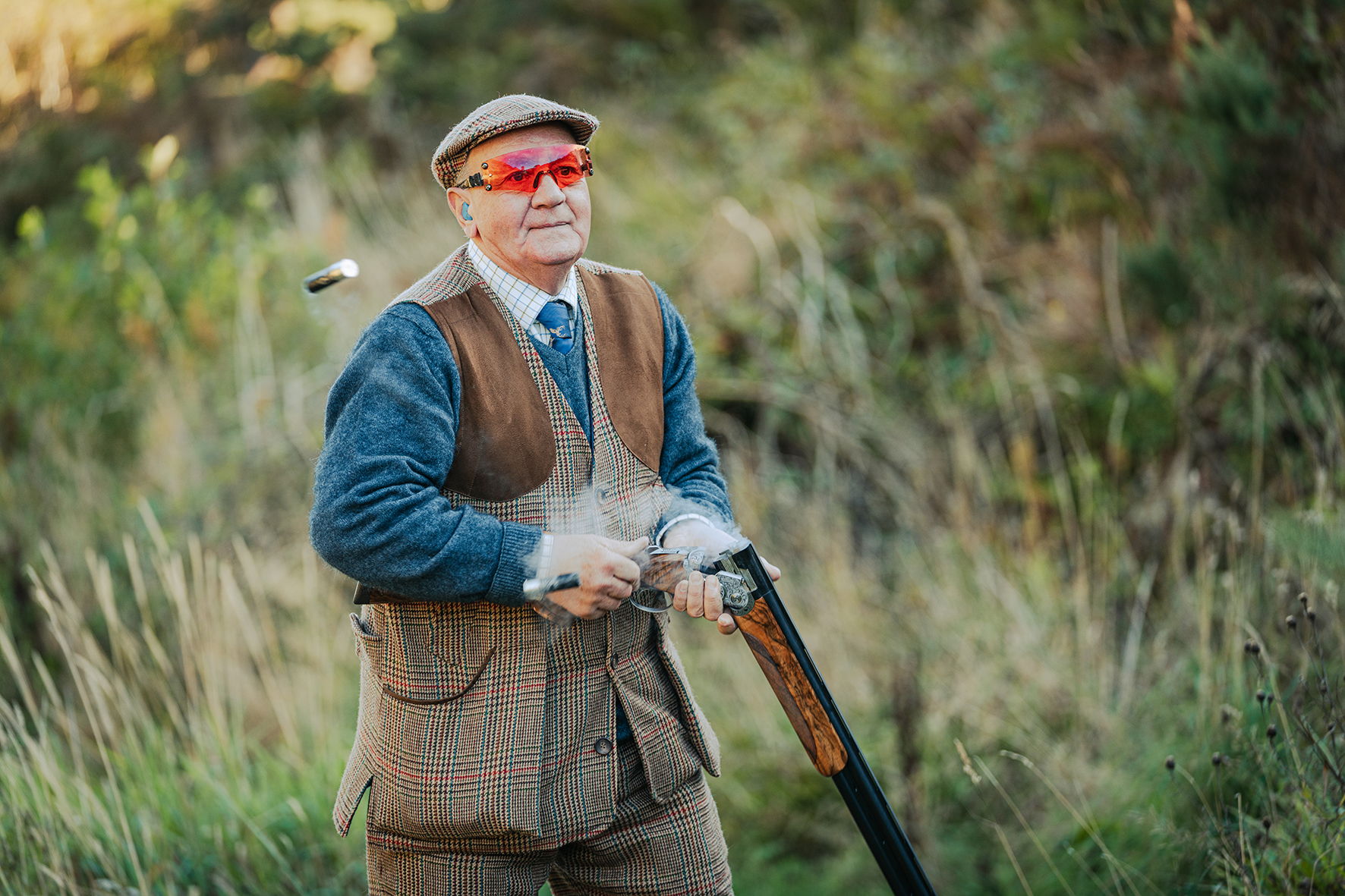 Portrait of shooter in traditional tweed attire during shooting party